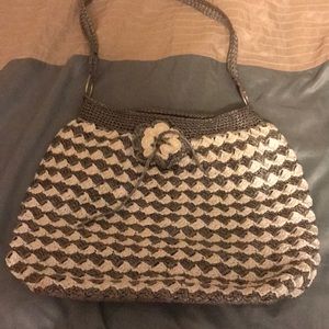 Plastic woven purse with material inside.